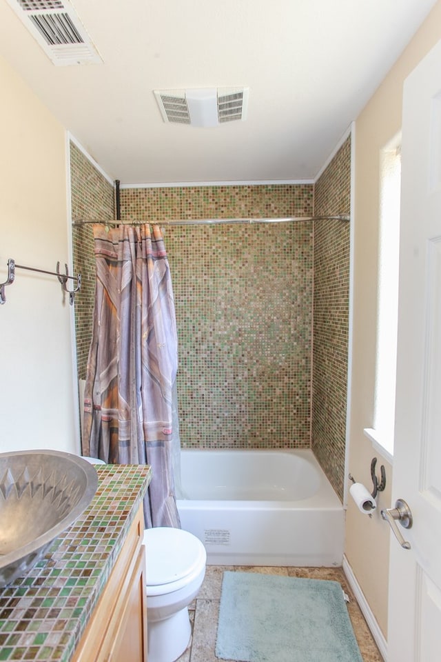 full bathroom with tile patterned floors, vanity, shower / bath combo, and toilet