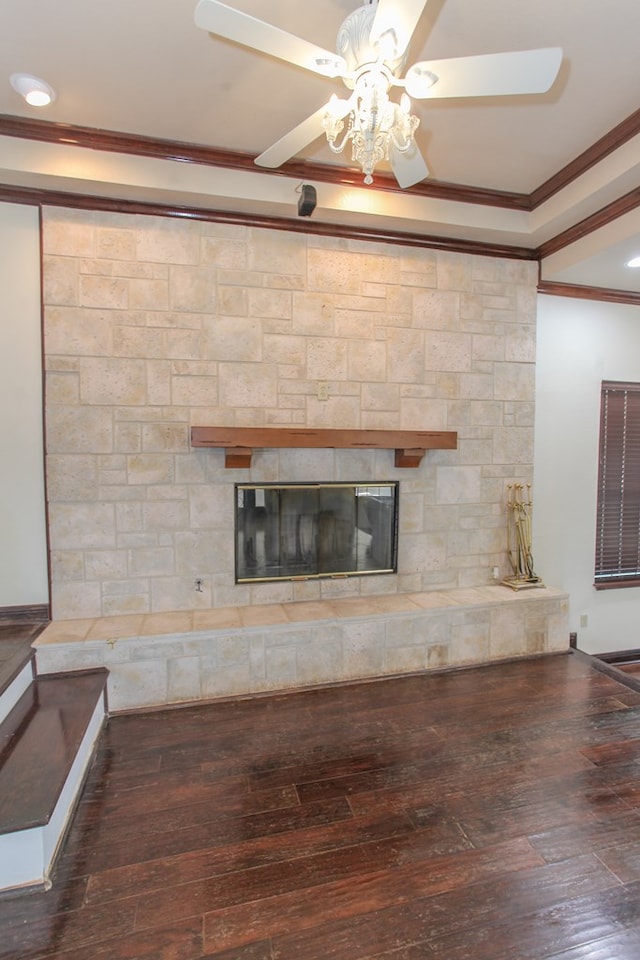 interior details with a stone fireplace, crown molding, and wood-type flooring