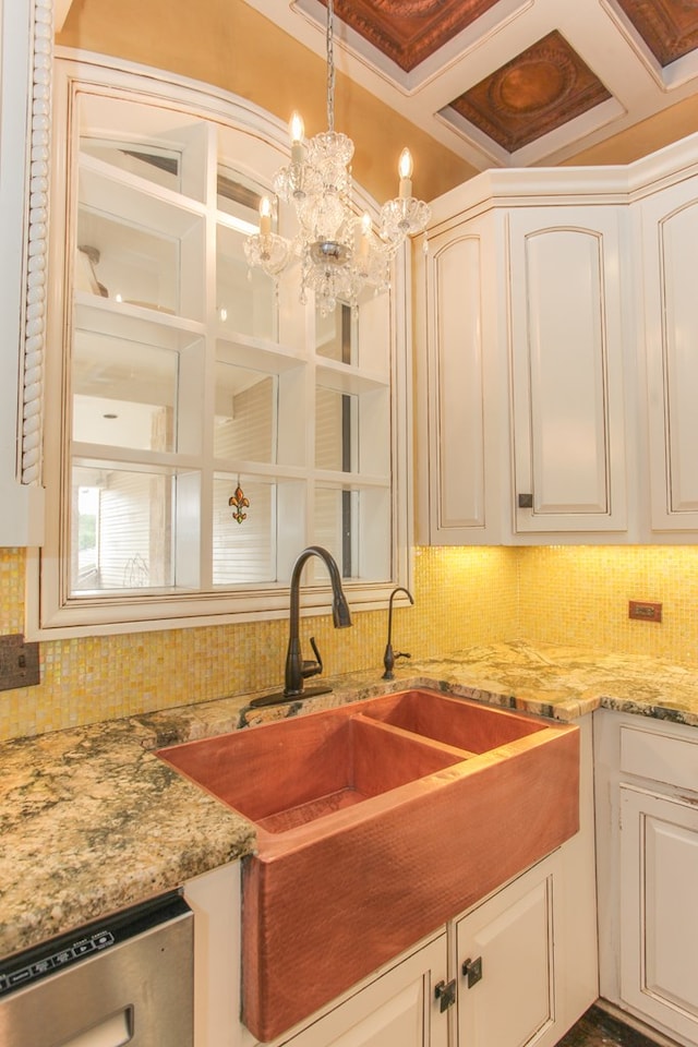 kitchen with stainless steel dishwasher, pendant lighting, white cabinets, and coffered ceiling