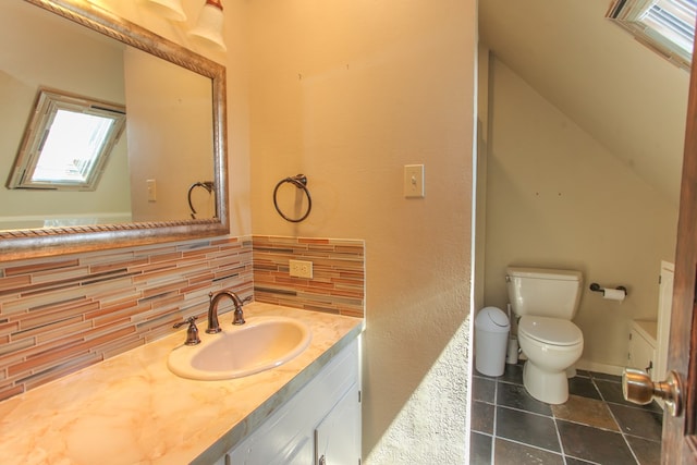 bathroom featuring tile patterned floors, decorative backsplash, vanity, and toilet