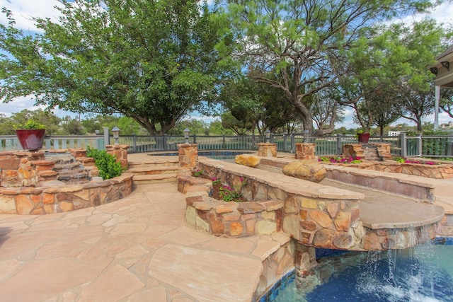 view of patio with pool water feature