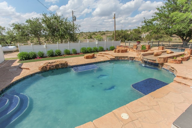 view of pool with a patio area and pool water feature