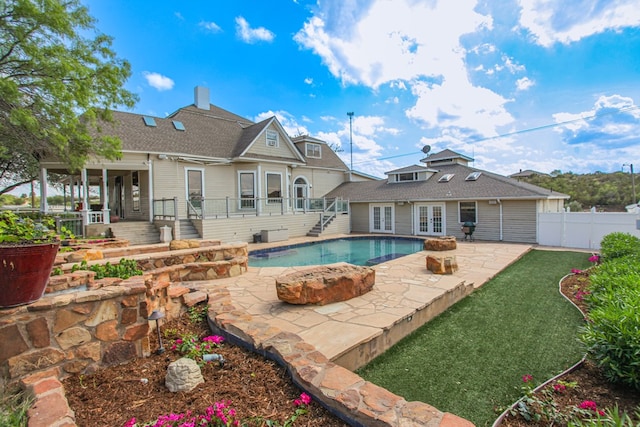 view of pool featuring a patio area and french doors