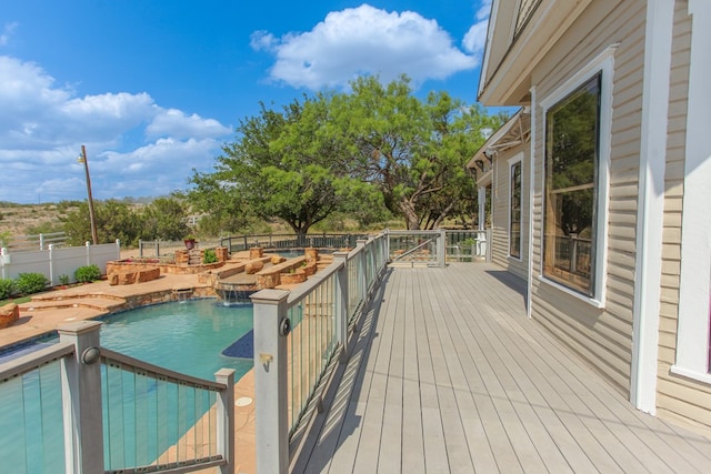 view of pool with pool water feature and a wooden deck