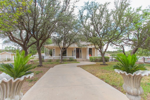 view of front of home featuring covered porch and a front yard