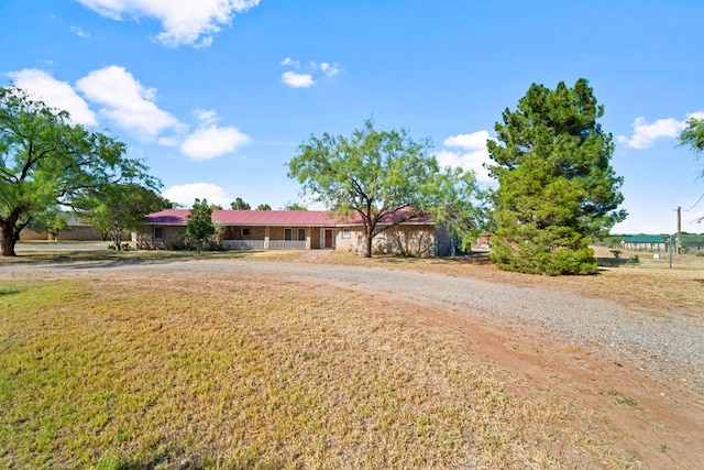 single story home featuring driveway and a front yard