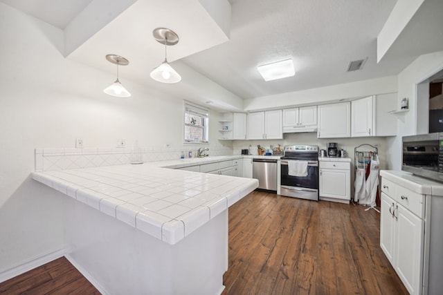 kitchen with pendant lighting, open shelves, stainless steel appliances, white cabinetry, and a peninsula