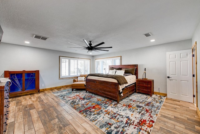 bedroom with a textured ceiling and ceiling fan