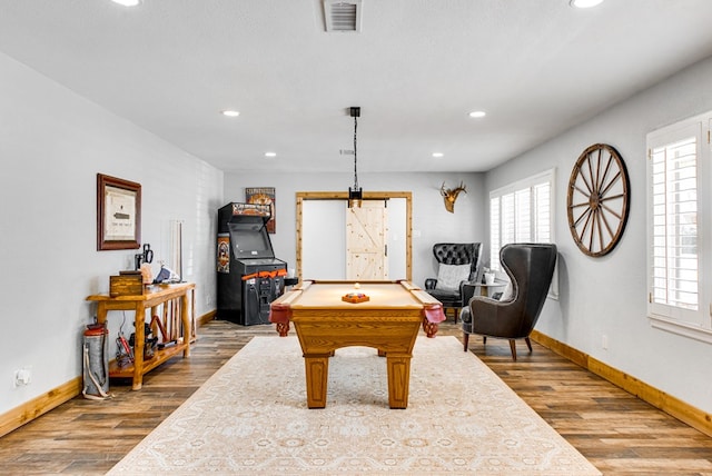 recreation room featuring wood-type flooring, billiards, and a textured ceiling