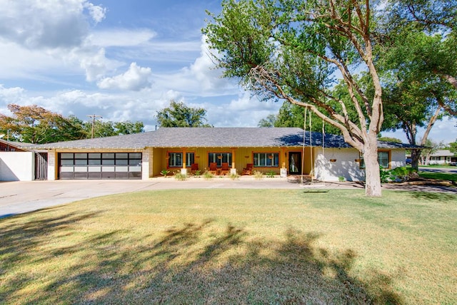 ranch-style home featuring a garage and a front lawn