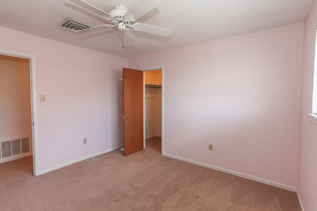 1900 Goliad St, Big Spring, TX 79720 - unfurnished bedroom with light carpet, baseboards, a closet, a walk in closet, and a ceiling fan