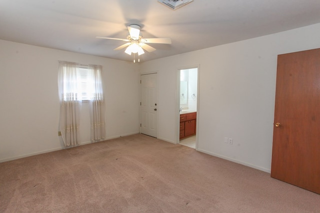 1900 Goliad St, Big Spring, TX 79720 - empty room with light carpet, a ceiling fan, and baseboards