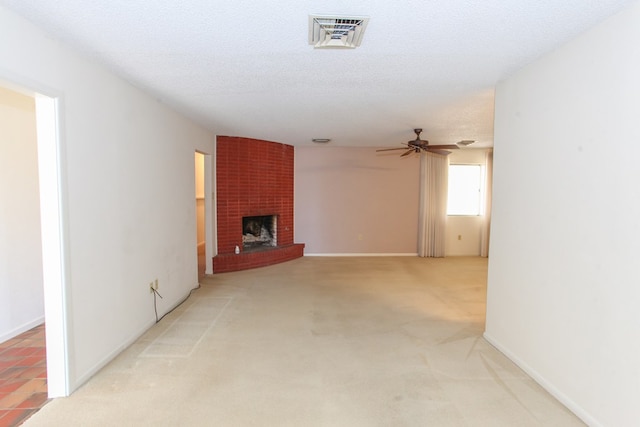 1900 Goliad St, Big Spring, TX 79720 - unfurnished living room featuring a ceiling fan, a brick fireplace, carpet, and baseboards