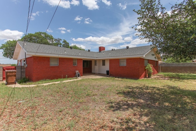 1900 Goliad St, Big Spring, TX 79720 - rear view of property featuring brick siding, a patio, and a chimney