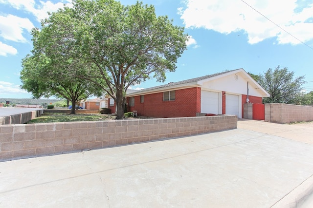 1900 Goliad St, Big Spring, TX 79720 - ranch-style home featuring an attached garage, driveway, and brick siding