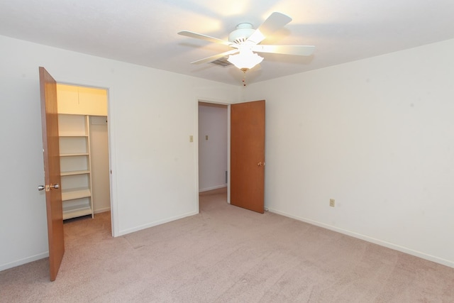 1900 Goliad St, Big Spring, TX 79720 - unfurnished bedroom featuring light carpet, a walk in closet, baseboards, and a closet