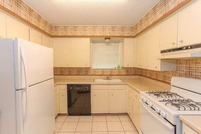 1900 Goliad St, Big Spring, TX 79720 - kitchen featuring white appliances, a sink, under cabinet range hood, light countertops, and a textured ceiling