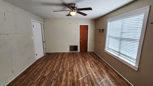 spare room featuring ceiling fan, wood finished floors, and visible vents