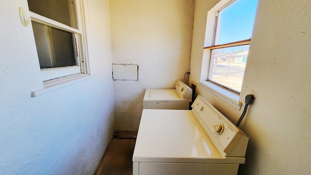 clothes washing area featuring laundry area and washing machine and dryer