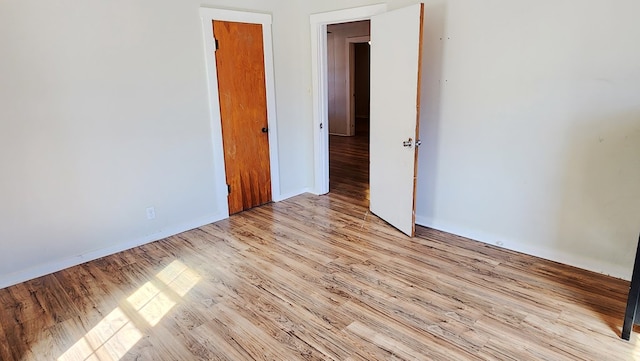 unfurnished room with light wood-type flooring