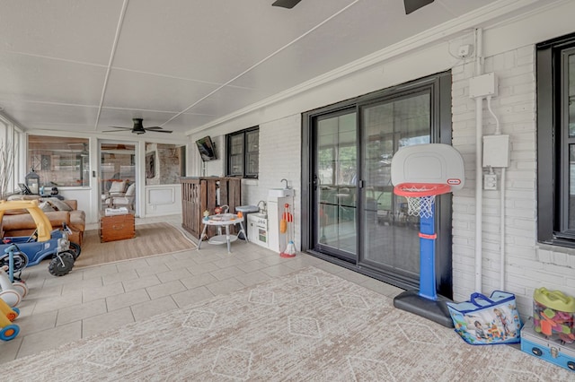 2602 N L St, Midland, TX 79705 - sunroom / solarium featuring ceiling fan, tile patterned floors, and brick wall