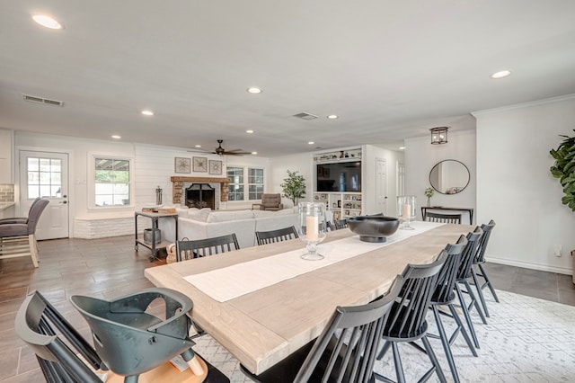 2602 N L St, Midland, TX 79705 - dining area featuring recessed lighting, a stone fireplace, a ceiling fan, crown molding, and baseboards