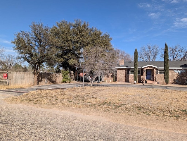 view of front of property featuring fence