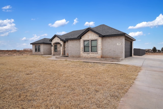 view of front of property with a garage and a front lawn