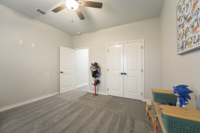 carpeted bedroom featuring a closet and ceiling fan