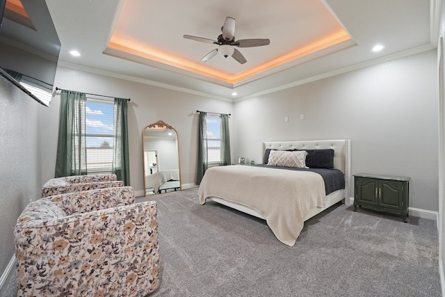 bedroom with crown molding, carpet flooring, and a raised ceiling