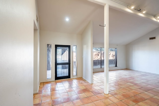 foyer entrance with high vaulted ceiling and visible vents