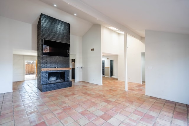 unfurnished living room with light tile patterned floors, high vaulted ceiling, a fireplace, and recessed lighting