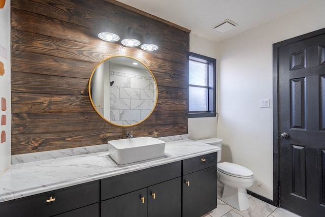 bathroom featuring visible vents, marble finish floor, toilet, and vanity