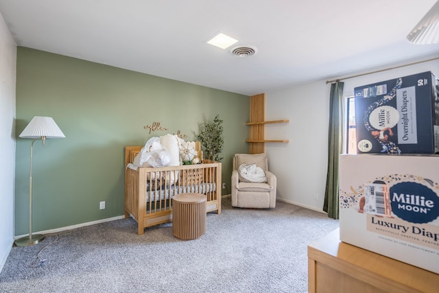 carpeted bedroom with a crib, baseboards, and visible vents