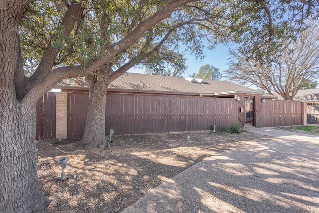 view of side of home with fence