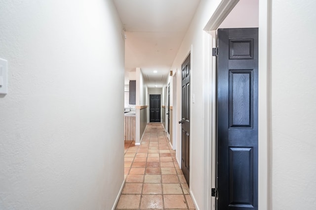 hall with attic access and baseboards