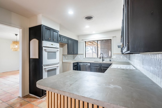 kitchen featuring light countertops, white appliances, visible vents, and decorative backsplash