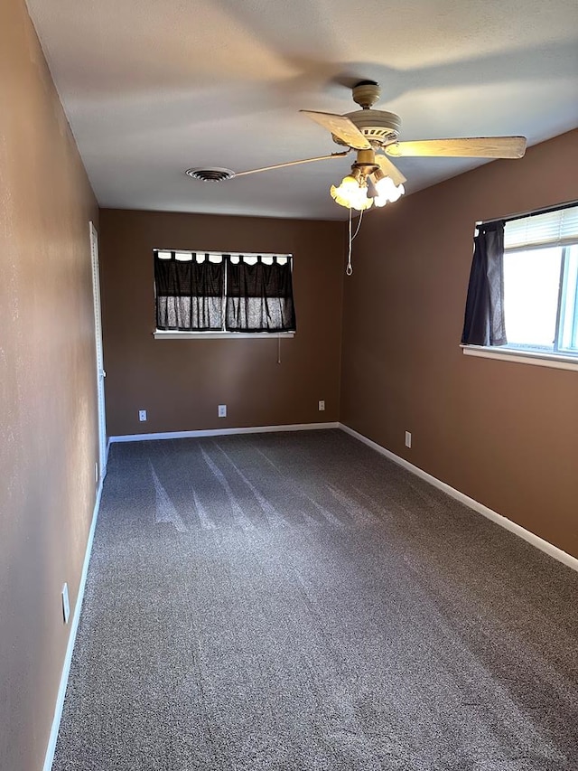 carpeted empty room featuring ceiling fan