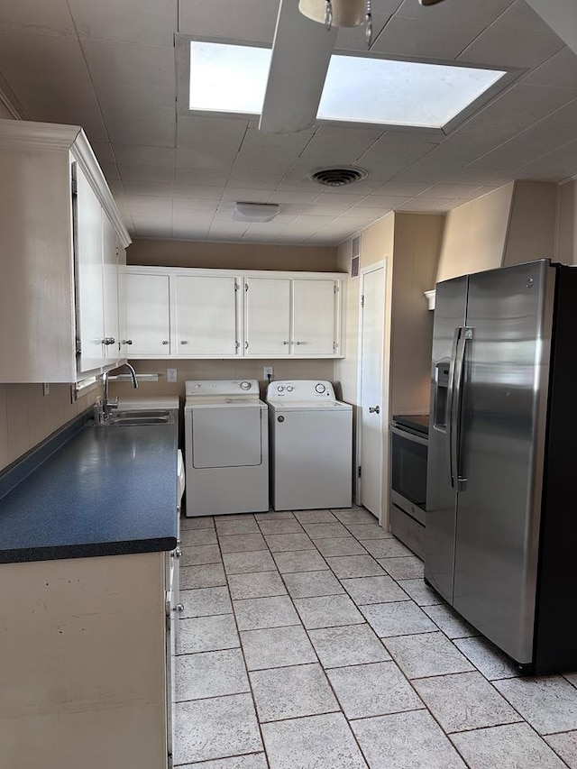 laundry area with separate washer and dryer and sink