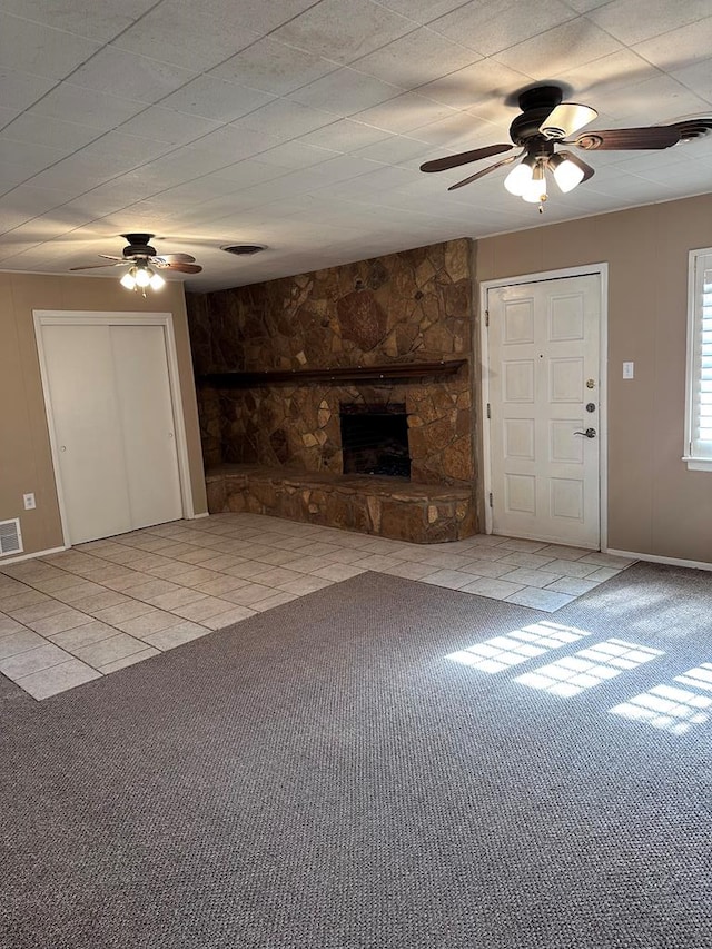 unfurnished living room with ceiling fan and light tile patterned floors