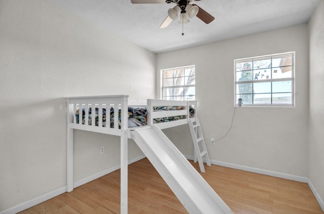 2401 Morrison Dr, Big Spring, TX 79720 - bedroom with baseboards, wood finished floors, and a ceiling fan