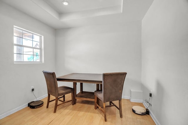 2401 Morrison Dr, Big Spring, TX 79720 - dining area with baseboards, a tray ceiling, and light wood finished floors