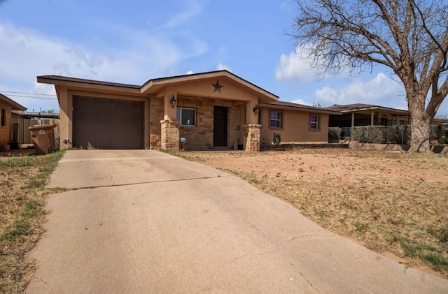 2401 Morrison Dr, Big Spring, TX 79720 - single story home featuring stone siding, fence, a garage, stucco siding, and driveway
