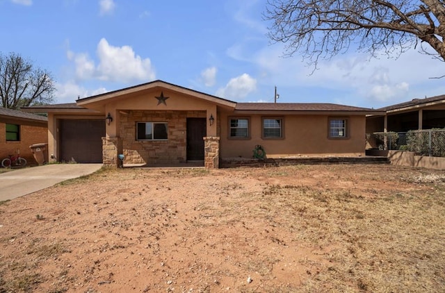 2401 Morrison Dr, Big Spring, TX 79720 - ranch-style house featuring stone siding, driveway, stucco siding, and an attached garage