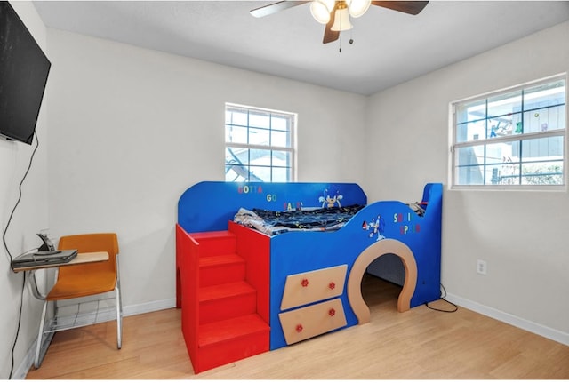 2401 Morrison Dr, Big Spring, TX 79720 - bedroom with baseboards, ceiling fan, and wood finished floors
