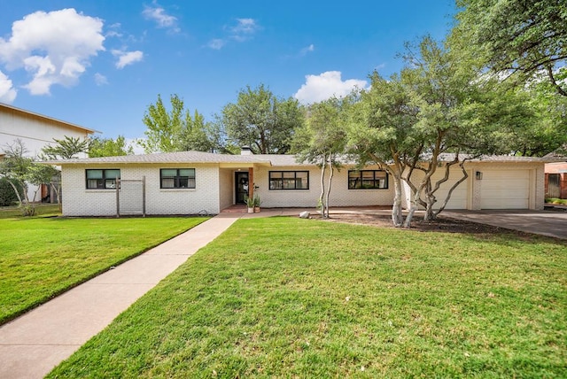 907 Harvard Ave, Midland, TX 79701 - ranch-style house featuring a front lawn, brick siding, concrete driveway, and a chimney