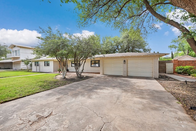 907 Harvard Ave, Midland, TX 79701 - view of front of home with brick siding, concrete driveway, and a garage