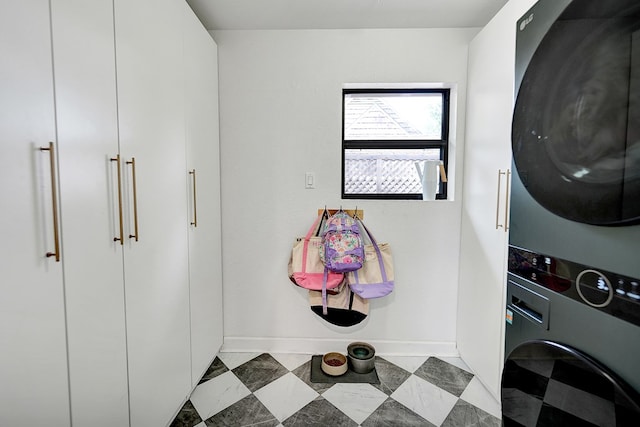 907 Harvard Ave, Midland, TX 79701 - laundry area with stacked washing machine and dryer and baseboards