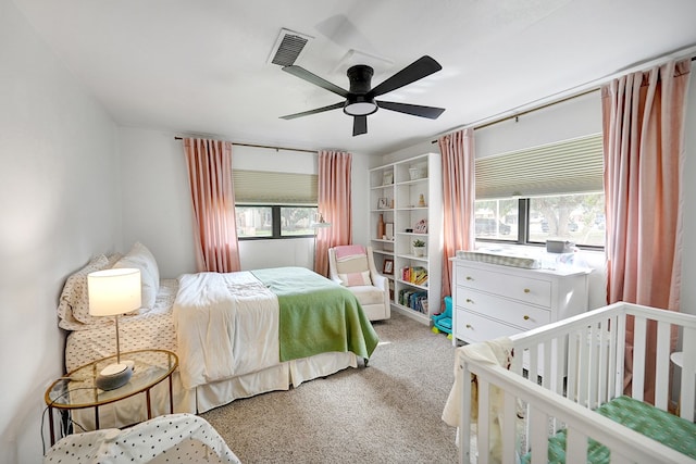 907 Harvard Ave, Midland, TX 79701 - carpeted bedroom featuring multiple windows and ceiling fan