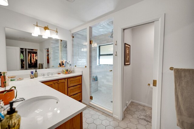 907 Harvard Ave, Midland, TX 79701 - full bath with a shower stall, a walk in closet, tile patterned floors, and vanity
